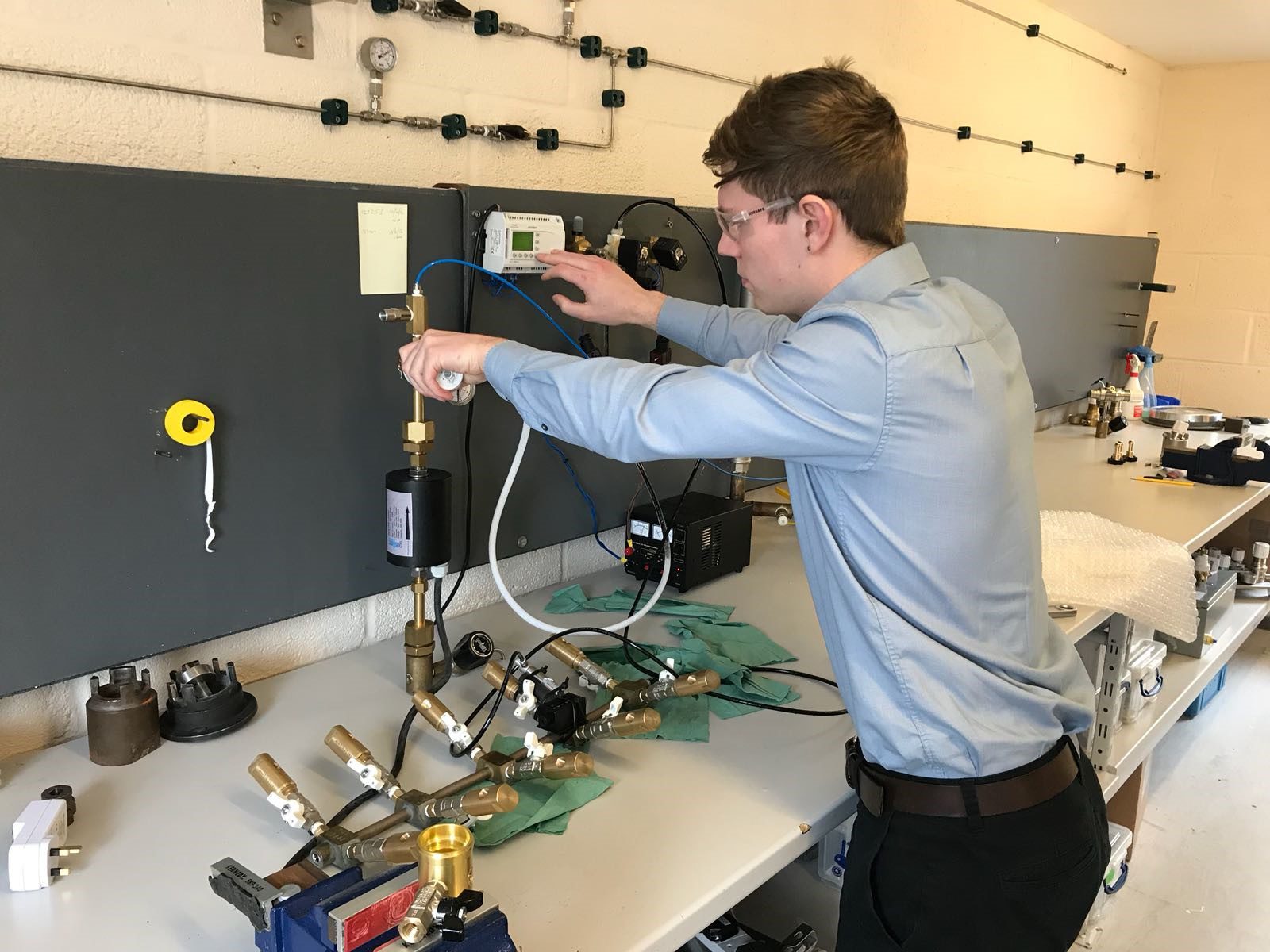 Company Image (GASARC: Apprentice using some equipment in lab)